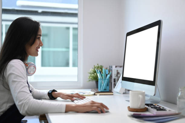 istock Side view of young woman designer working with her professional computer at her workspace. 1293591467