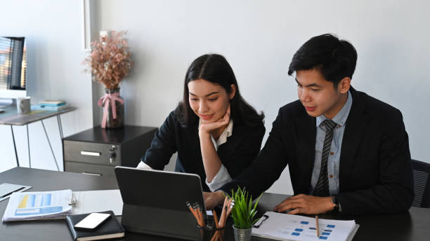 istock Shot of businesspeople analyzing documents while sitting at office desk in office. 1293592260