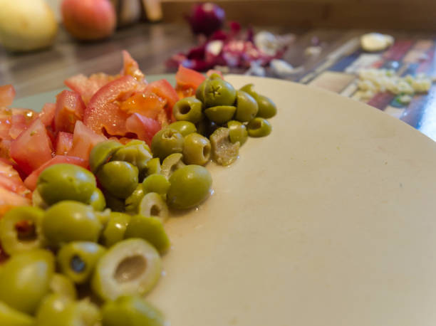 istock Preparing tomatoes and green olive for salad 1293595265
