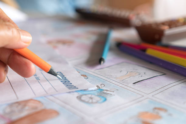 istock Hands drawing storyboard animation comic for pre-production process, design creative story scene layout in movie carton at studio. Behind making work before production film or video presentation 1293595587