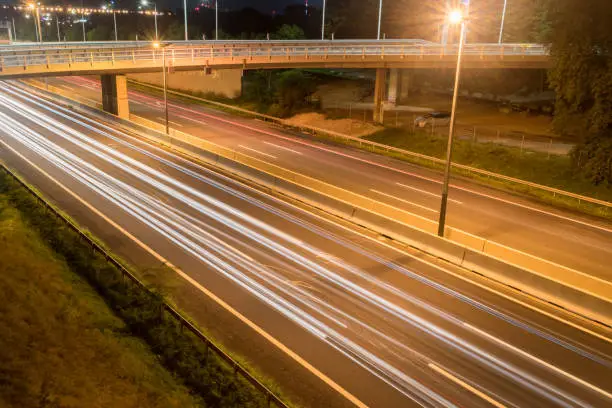 Photo of Car light trails on highway at night in Vienna, Austria.
