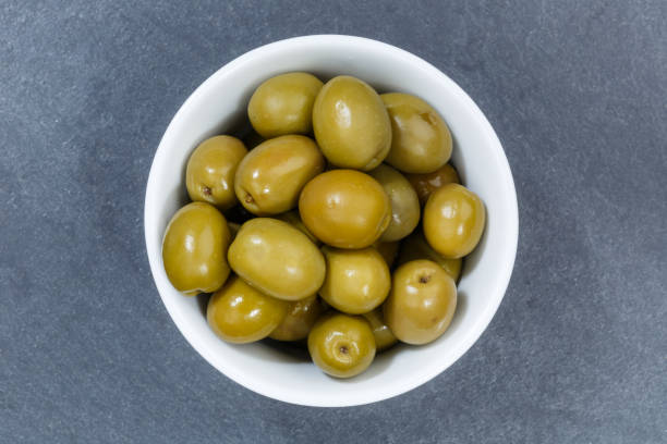 istock Olives green olive from above bowl on a slate 1293599242