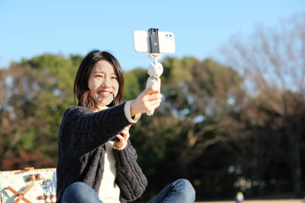 Woman vlogging at picnic