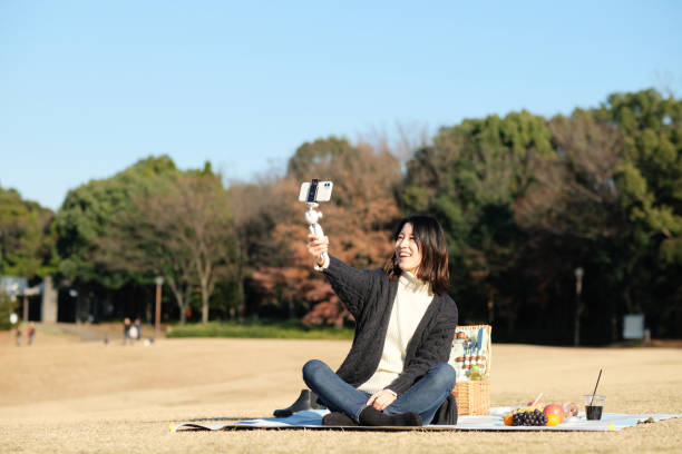 istock Woman vlogging at picnic 1293599477