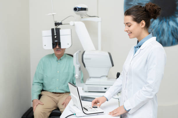 istock Happy young female ophthalmologist in whitecoat using eyesight testing equipment 1293601805