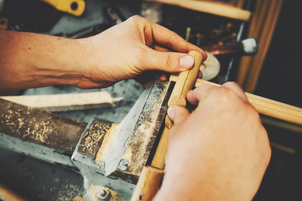 istock Handmade in a carpenter's workshop. Male hands close up while working. 1293602736