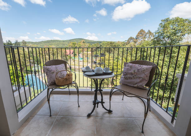 istock Afternoon tea with dessert and pillow on weave chairs on balcony 1293604675