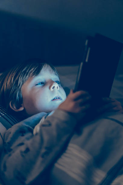 istock toddler boy watching cartoons on the tablet before going to bed 1293606005
