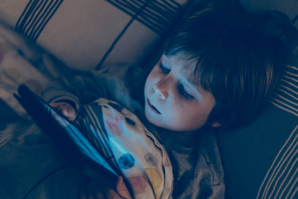 istock toddler boy watching cartoons on the tablet before going to bed 1293606563