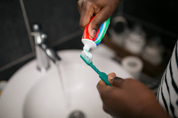 An unrecognizable African American man maintaining his personal hygiene