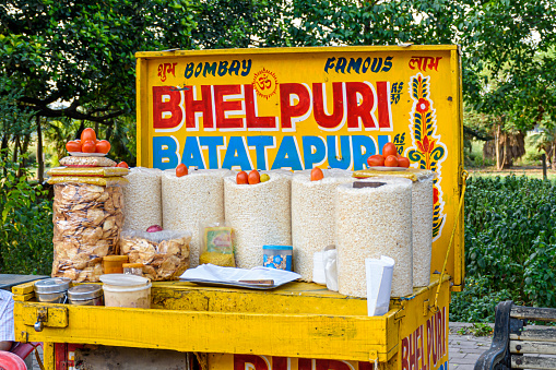 Papri chat, bhel puri and wide variety of chats being sold by a fast food vendor in his cart beside a road in Kolkata, India on May 2019