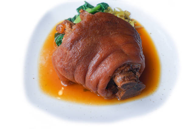 traditional local  style pork leg in  sauce with mashed served on white plate dish