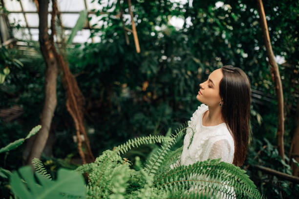 istock Young woman relaxes and enjoys inside orangery. 1293615603