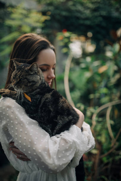 istock Young woman holds and embraces cat. 1293615659