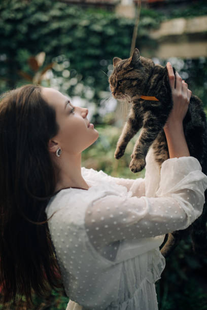 istock Young woman holds and embraces cat. 1293615744