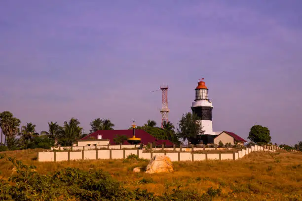 A view of a lighthouse standing at the coast of Muttom beach, Tamil Nadu, India
