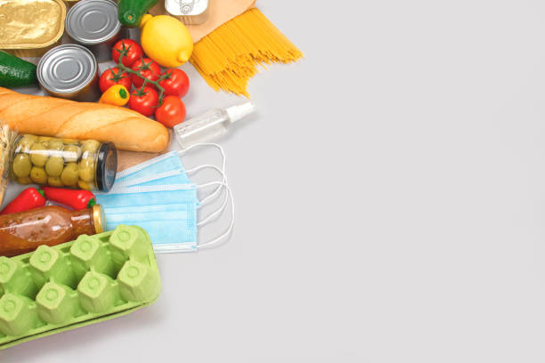 istock Flat lay composition with food and medicines donations on grey background with copyspace - pasta, fresh vegatables, canned food, baguette, cooking oil. Food donations and food bank concept 1293618908