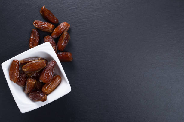 istock dates. dried fruits on a stone slab. top view. copy space 1293619226