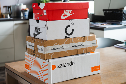 Amsterdam, Jisperveldstraat, the Netherlands, 12-29-2019. Zalando, de bijenkorf package ready to send back, sealed box, online shopping, return to sender, retail, e-tail, Nike shoe box,