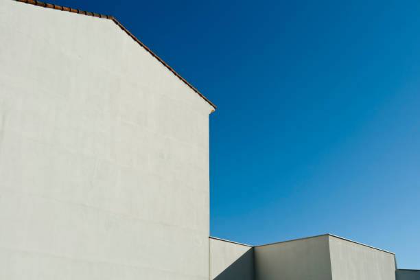 istock White walls in front of blue sky 1293621017