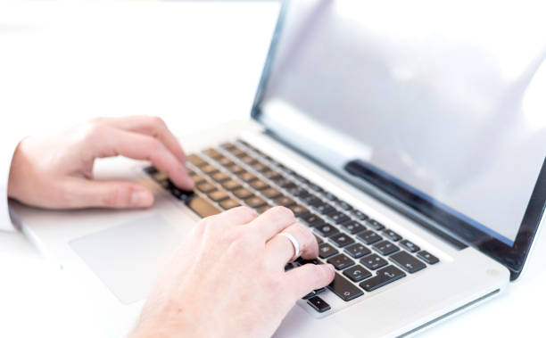 istock Close up hands of married boy typing on modern laptop 1293621374