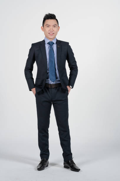 istock Asian Chinese young businessman with coat in white background studio 1293621476