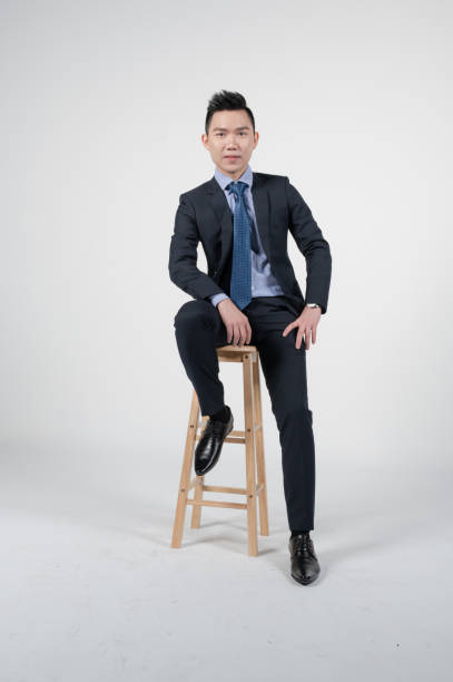 istock Asian Chinese young businessman with coat in white background studio 1293621499