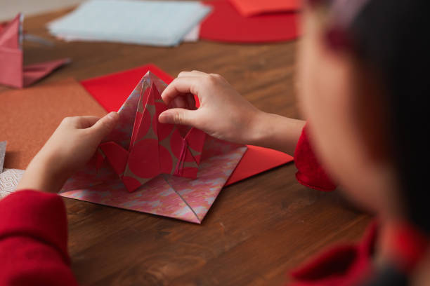 istock Unrecognizable Girl Making Paper Crane 1293621600