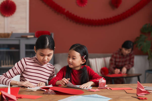 istock Chinese Girls Making Paper Decorations 1293621619