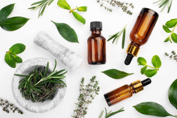 istock Dropper bottles with oil and mortar with herbs on white table flat lay view. Herbal cosmetics concept 1293622208