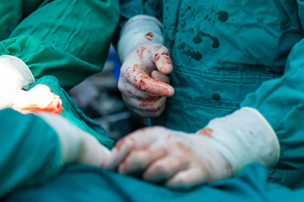 istock Surgical hands with blood during the surgery 1293622219