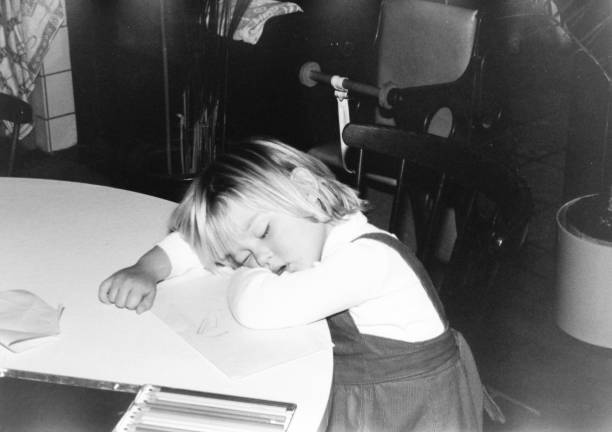 Sleeping girl resting her head on the table.
