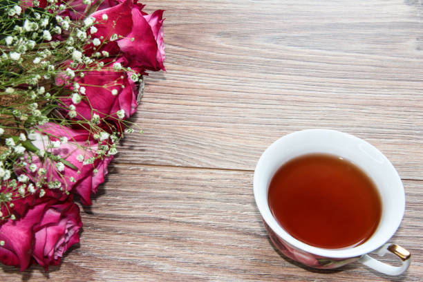 istock A Cup of tea with roses on a wooden background. 1293624916