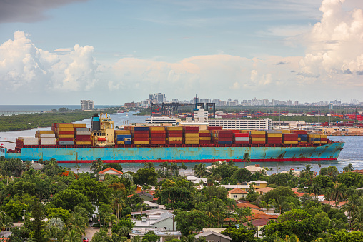 A cargo ship passes through the rivers of Ft. Lauderdale, Florida, USA.
