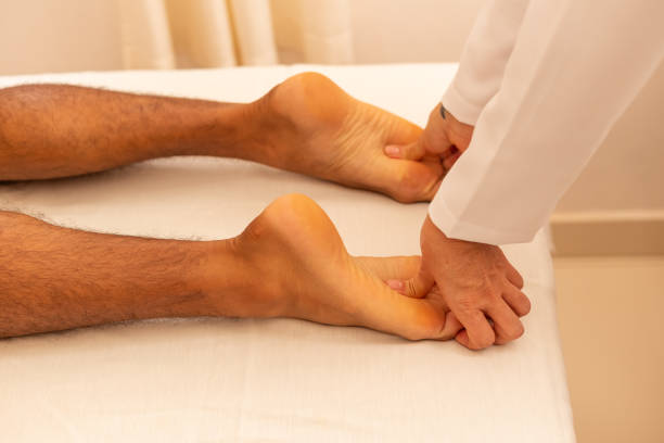 istock Massage therapist applying foot massage to patient. 1293626935