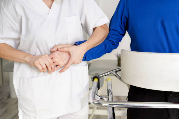 Physiotherapist assisting a patient with Amyotrophic Lateral Sclerosis. High quality photo Physiotherapist assisting a patient with Amyotrophic Lateral Sclerosis. High quality photo sclerosis stock pictures, royalty-free photos & images