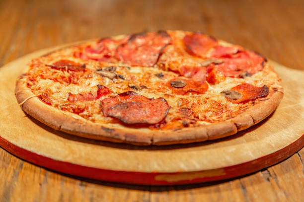 istock Freshly baked appetizing pizza with cheese and spices 1293627845