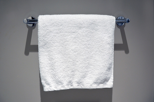 Plain white towel and towel bar in a luxury hotel