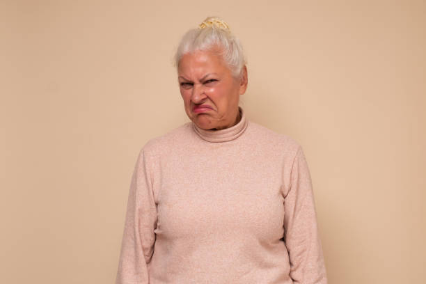 istock Suspicious elderly woman showing distrustful look at camera 1293630764