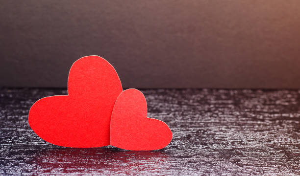 istock Red hearts on a black background. Valentine. 1293633366