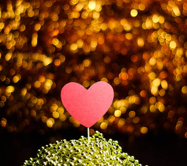 istock Heart on a stick on a background with Golden bokeh. 1293633461