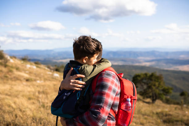 istock Father carrying his son while hiking 1293634300