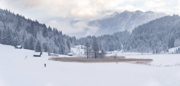 istock winter landscape panorama with snow covered huts and mountains 1293634357