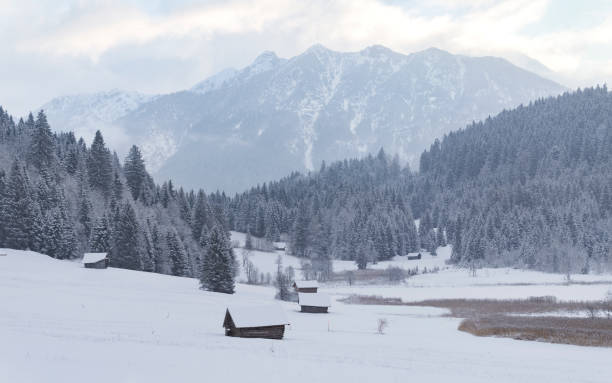 istock winter landscape panorama with snow covered huts and mountains 1293634402