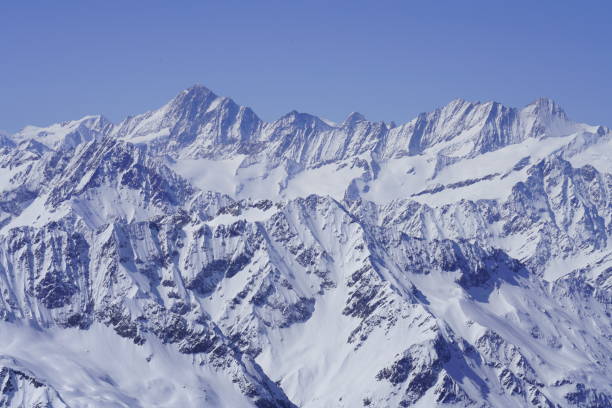 istock Snow-covered mountains and beautiful blue sky in winter 1293634590