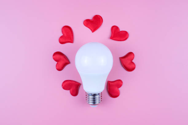 istock A light bulb and red hearts on a pink background. Valentine's Day concept 1293634606