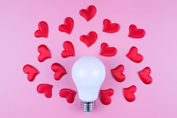 istock A light bulb and red hearts on a pink background. Valentine's Day concept 1293634617