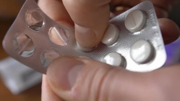 istock Pushing Drugs Pills Through Blister Package Close-Up 1293635979
