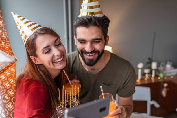 istock Happy couple on a video call, celebrating birthday 1293636942