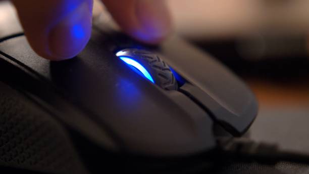 istock Caucasian Male Hand Using Computer Mouse Buttons and Wheel in the Dark Close Up 1293636949
